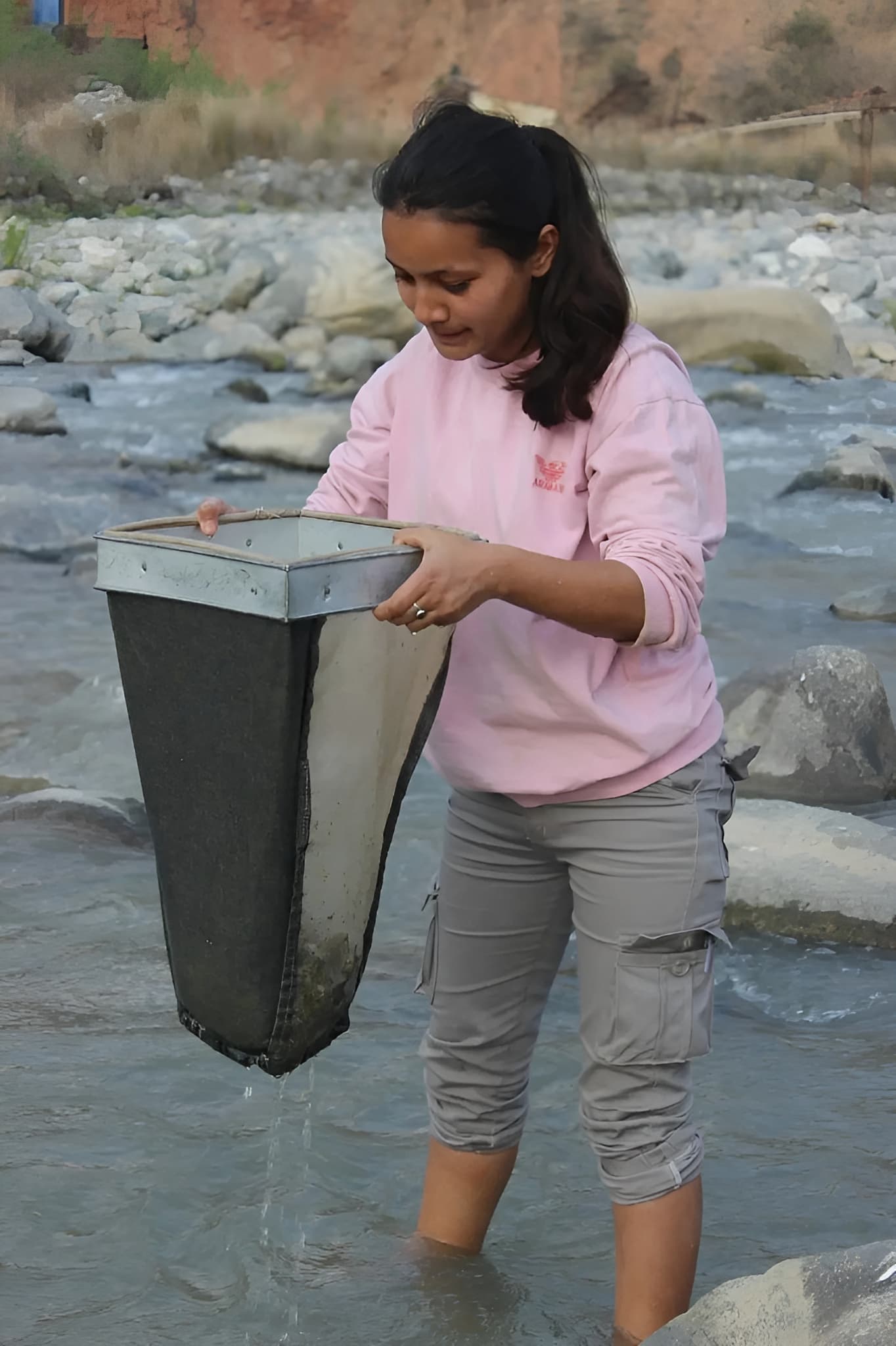 Somy Bhattarai collecting river samples during field research